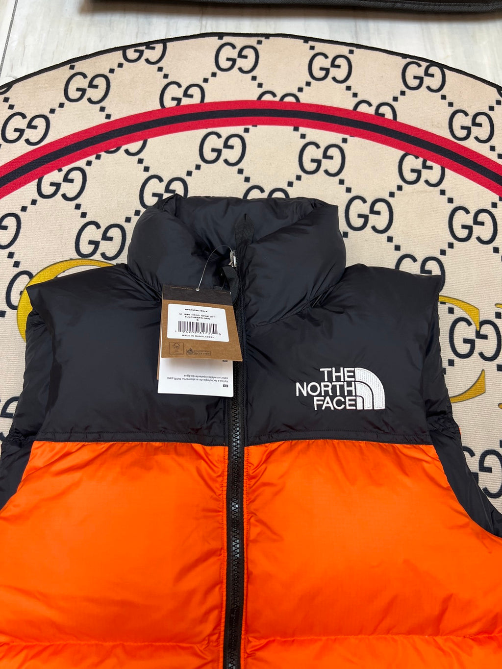 The North Face Orange and Black Colorblock Puffer Vest